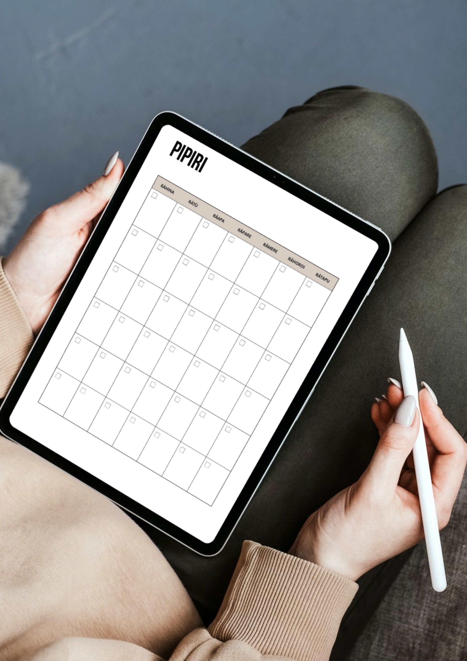 Person holding a tablet with a grid layout app on a dark surface
